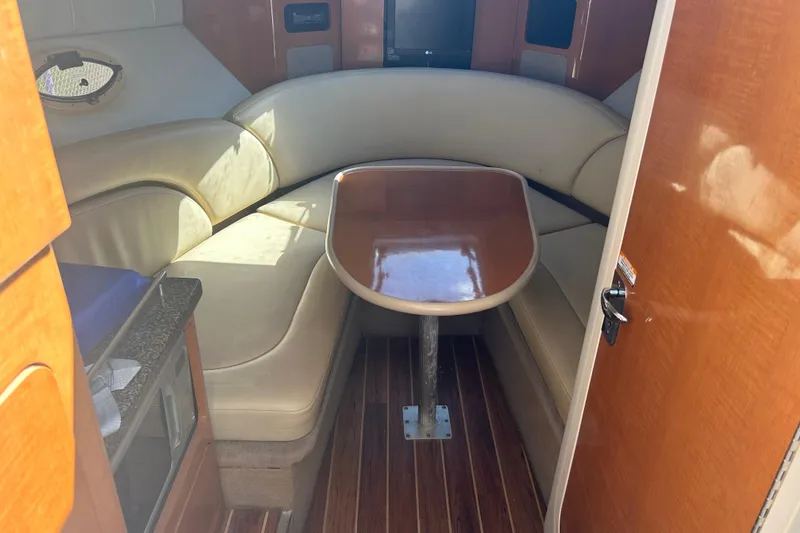 Slide: The Image of 2008 Chaparral 275 SSi cabin interior with seating and wooden table. - 20