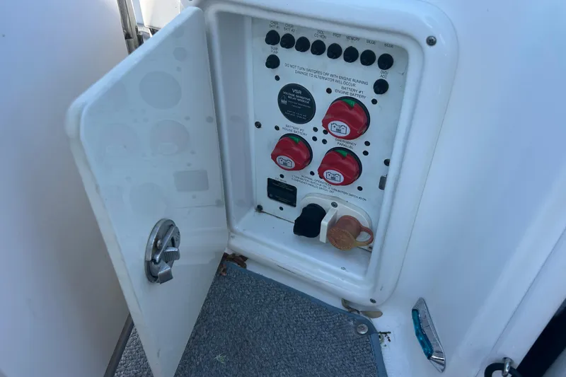 Slide: The Image of Electrical panel inside a 2008 Chaparral 275 SSi boat, featuring battery switches and controls. - 25