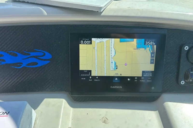 Slide: The Image of Garmin GPS display on 2008 Chaparral 275 SSi boat dashboard with blue flame decal. - 34