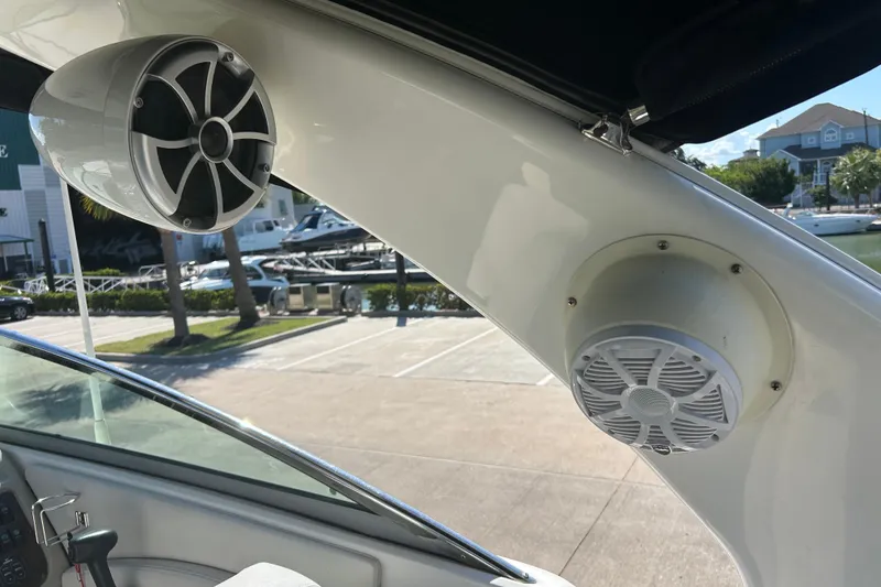 Slide: The Image of 2008 Chaparral 275 SSi boat speakers, docked with marina view in background. - 38