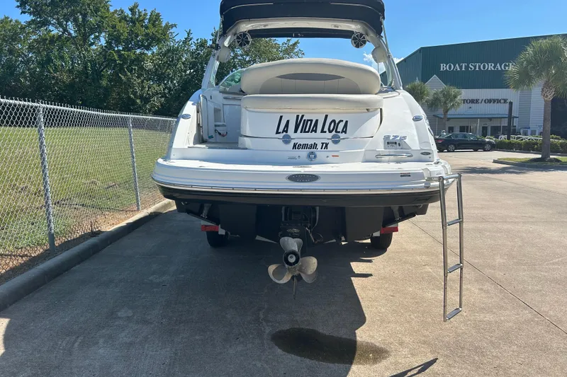 Slide: The Image of 2008 Chaparral 275 SSi boat, rear view, parked near boat storage facility. - 4