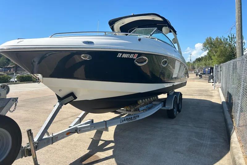 Slide: The Image of 2008 Chaparral 275 SSi boat on trailer, parked outdoors under clear blue sky. - 43