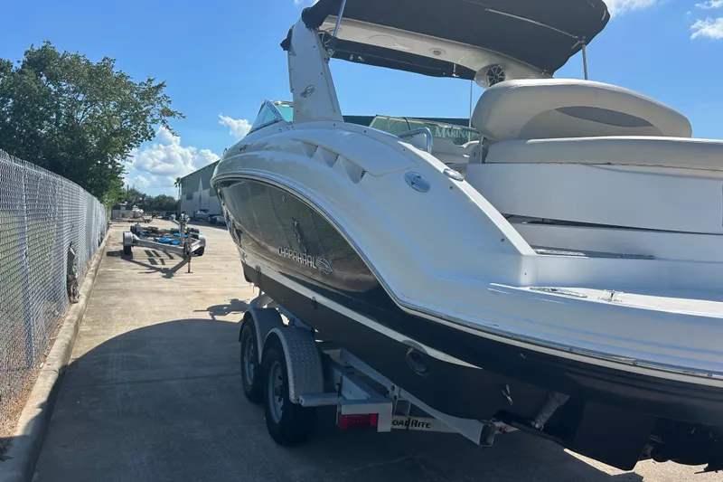 Slide: The Image of 2008 Chaparral 275 SSi boat on trailer, parked outdoors under clear sky. - 5