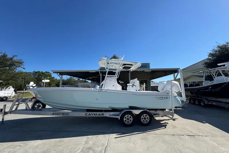 The Image of 2026 Caymas 281 HB boat on trailer under clear blue sky. - 1