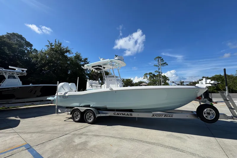 Slide: The Image of 2026 Caymas 281 HB boat on trailer under clear blue sky. - 11