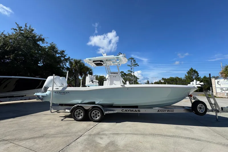 Slide: The Image of 2026 Caymas 281 HB boat on trailer under clear blue sky. - 12