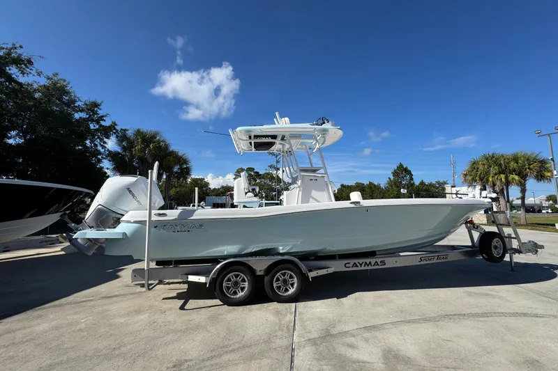 Slide: The Image of 2026 Caymas 281 HB boat on trailer under clear blue sky. - 13