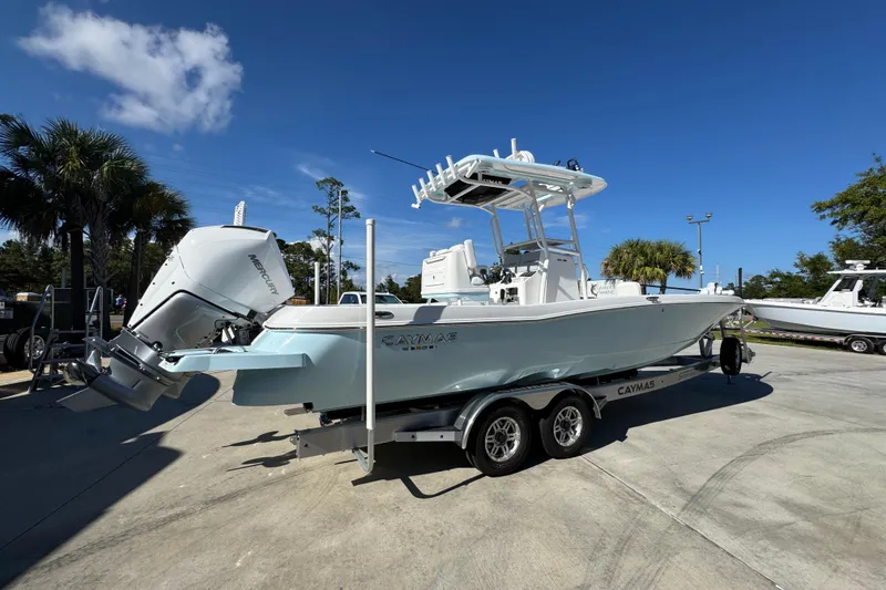 Slide: The Image of 2026 Caymas 281 HB boat on trailer, parked outdoors under clear blue sky. - 14