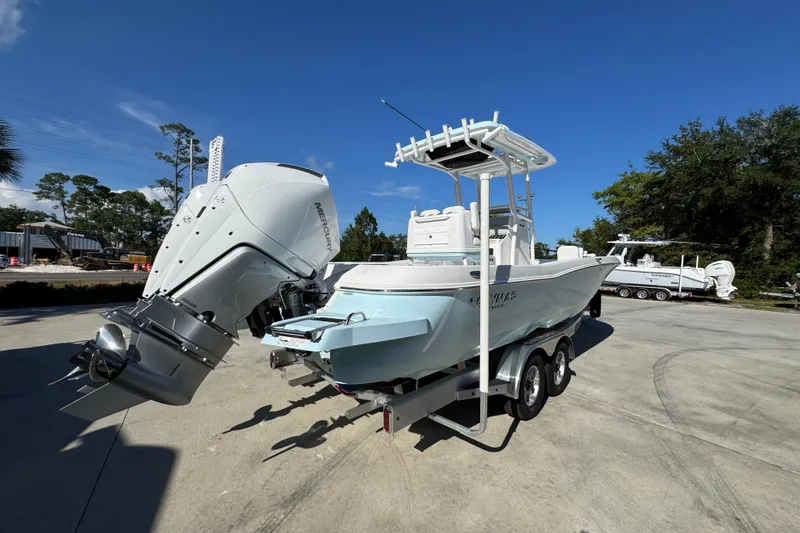 Slide: The Image of 2026 Caymas 281 HB boat on trailer with powerful outboard motor, clear blue sky. - 15