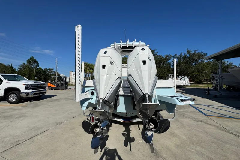 Slide: The Image of 2026 Caymas 281 HB boat with dual outboard engines in a sunny marina setting. - 17