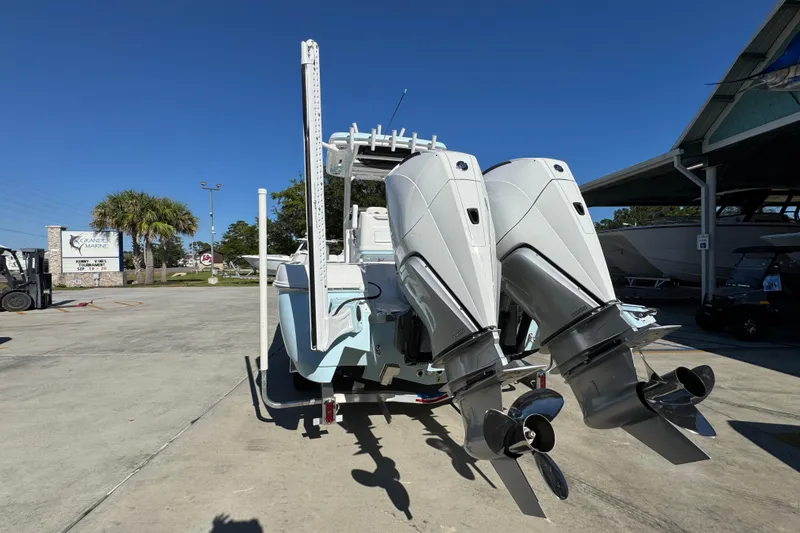 Slide: The Image of 2026 Caymas 281 HB boat with dual outboard engines in a marina setting. - 18