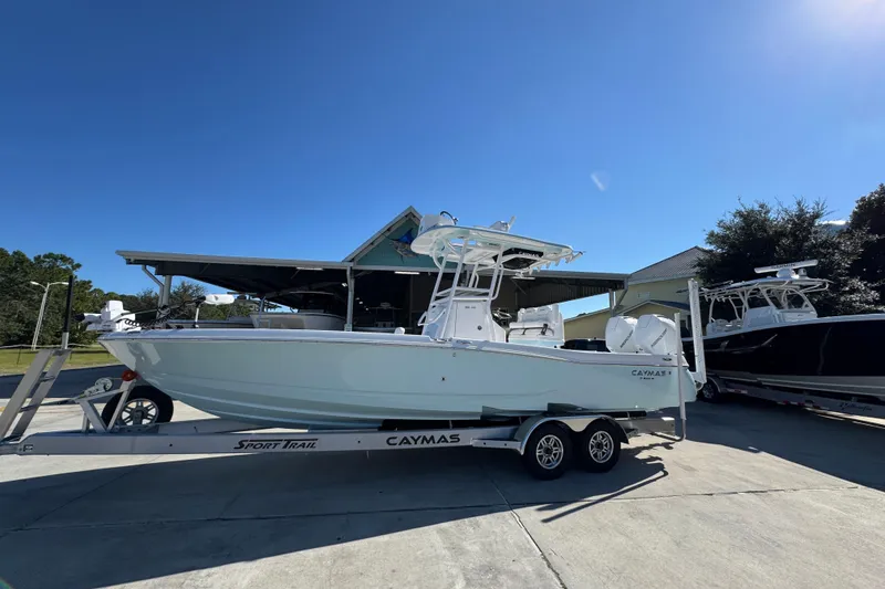 Slide: The Image of 2026 Caymas 281 HB boat on trailer under clear blue sky. - 2