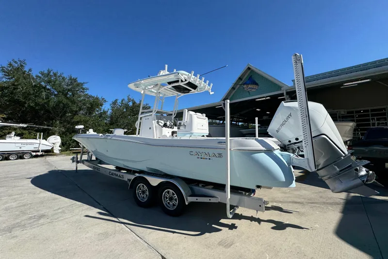 Slide: The Image of 2026 Caymas 281 HB boat on trailer, parked outdoors under clear blue sky. - 20
