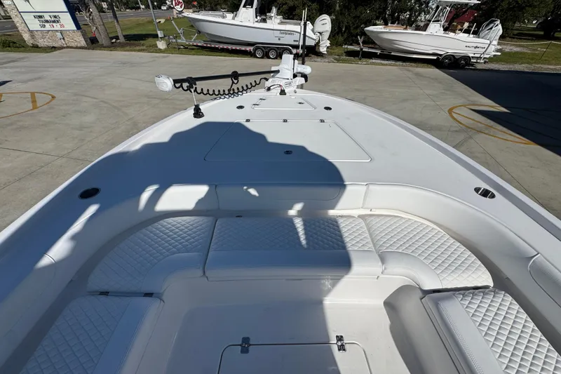 Slide: The Image of 2026 Caymas 281 HB boat interior with white cushioned seating and deck view. - 22