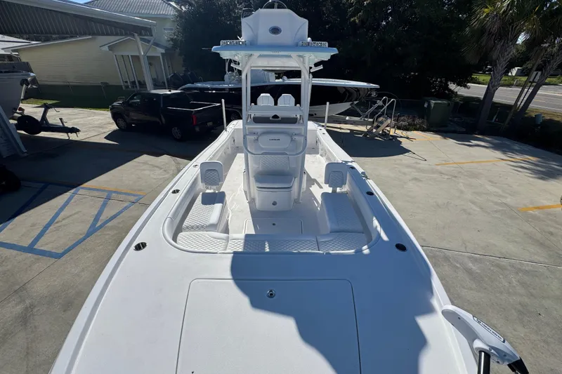 Slide: The Image of 2026 Caymas 281 HB boat with spacious deck and modern design in a marina setting. - 26