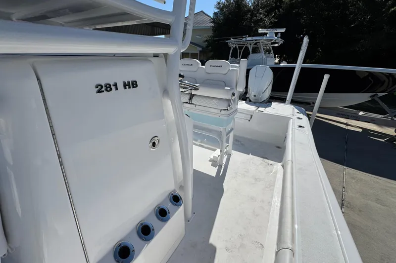 Slide: The Image of 2026 Caymas 281 HB boat interior with seating and fishing rod holders. - 29