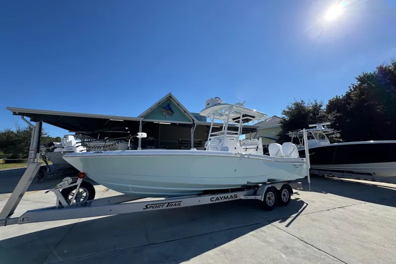 Slide: The Image of 2026 Caymas 281 HB boat on trailer under clear blue sky. - 3