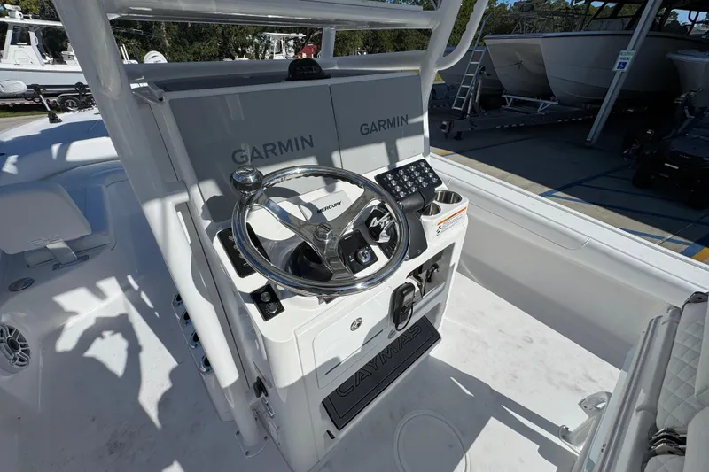 Slide: The Image of 2026 Caymas 281 HB boat console with Garmin navigation and Mercury steering wheel. - 33
