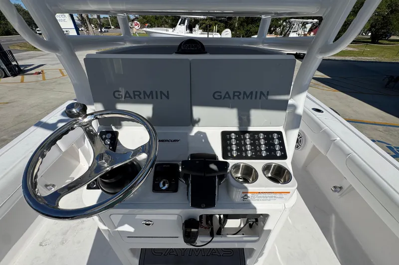 Slide: The Image of 2026 Caymas 281 HB boat console with Garmin displays and steering wheel. - 34