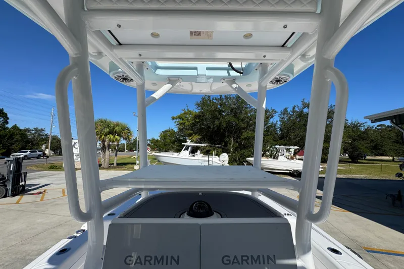 Slide: The Image of 2026 Caymas 281 HB boat with Garmin equipment, docked under clear blue sky. - 35
