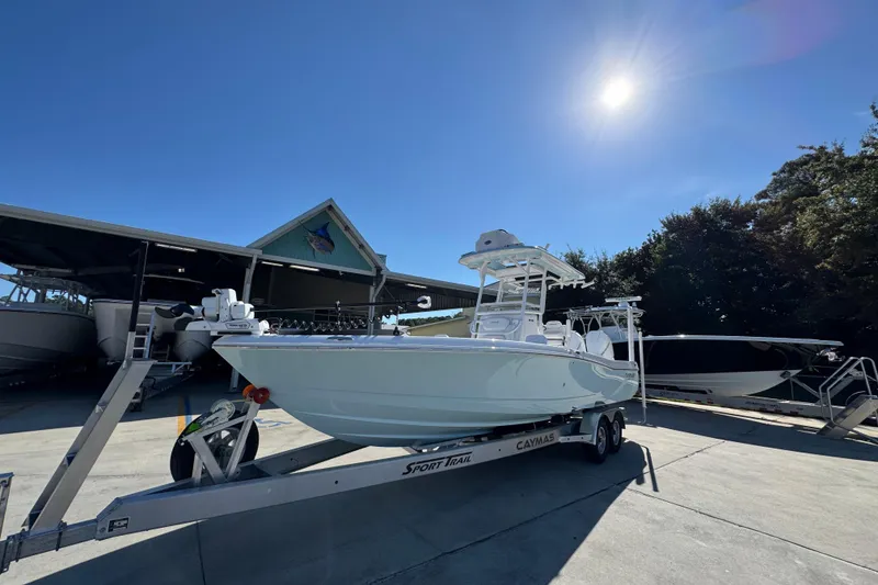 Slide: The Image of 2026 Caymas 281 HB boat on trailer under clear blue sky. - 4