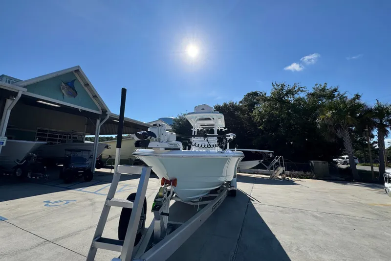 Slide: The Image of 2026 Caymas 281 HB boat on trailer under sunny sky at marina. - 6