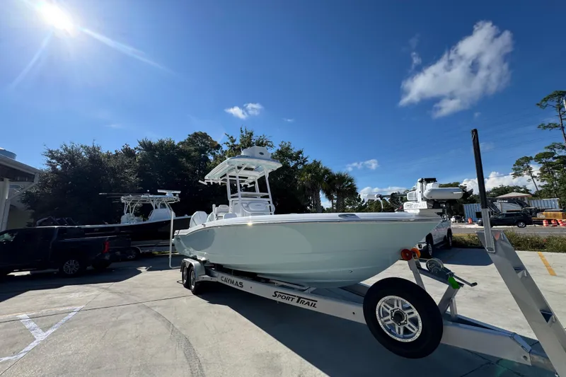 Slide: The Image of 2026 Caymas 281 HB boat on trailer under clear blue sky. - 9