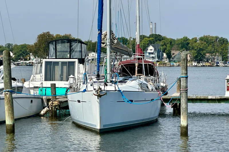 Slide: The Image of 2011 Beneteau Oceanis 40 sailboat on calm water, side view. - 2
