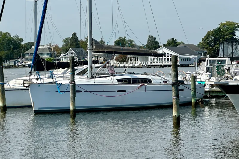 Slide: The Image of 2011 Beneteau Oceanis 40 sailboat docked in a marina, surrounded by other boats. - 3