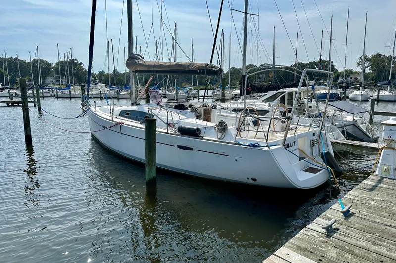 Slide: The Image of 2011 Beneteau Oceanis 40 sailboat docked in a marina, rear view. - 5
