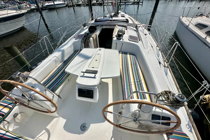 Slide: The Image of 2011 Beneteau Oceanis 40 sailboat cockpit with dual steering wheels, docked at marina. - 9