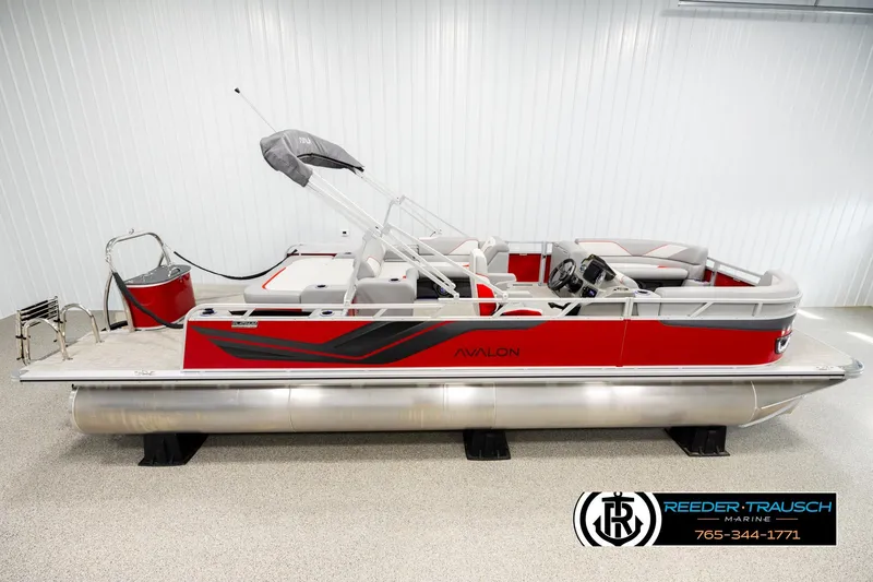 The Image of 2026 Avalon VEN85 VRB pontoon boat in showroom, featuring sleek red and gray design. - 1