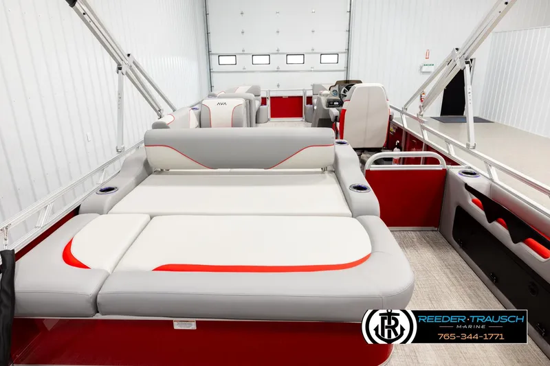Slide: The Image of 2026 Avalon VEN85 VRB pontoon boat interior with red and gray seating in a showroom. - 16