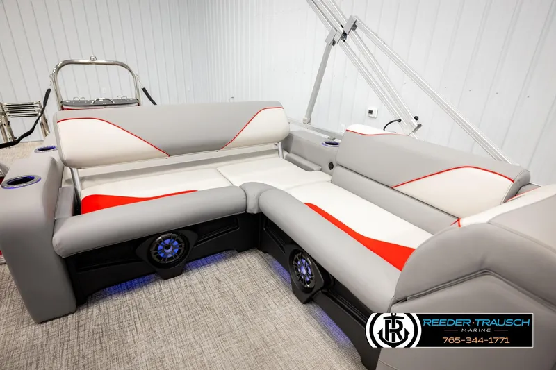 Slide: The Image of 2026 Avalon VEN85 VRB boat interior with gray and red seating, cup holders, and speakers. - 23