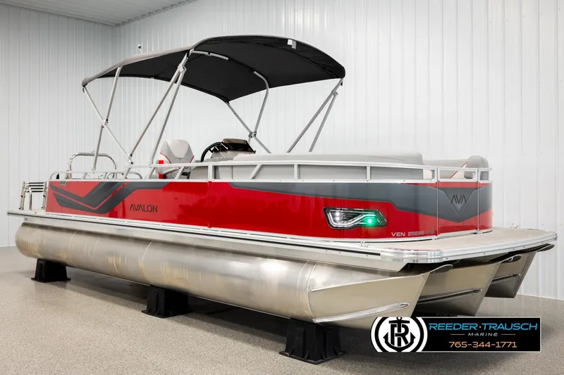 Slide: The Image of 2026 Avalon VEN85 VRB pontoon boat with red and gray design in showroom. - 3