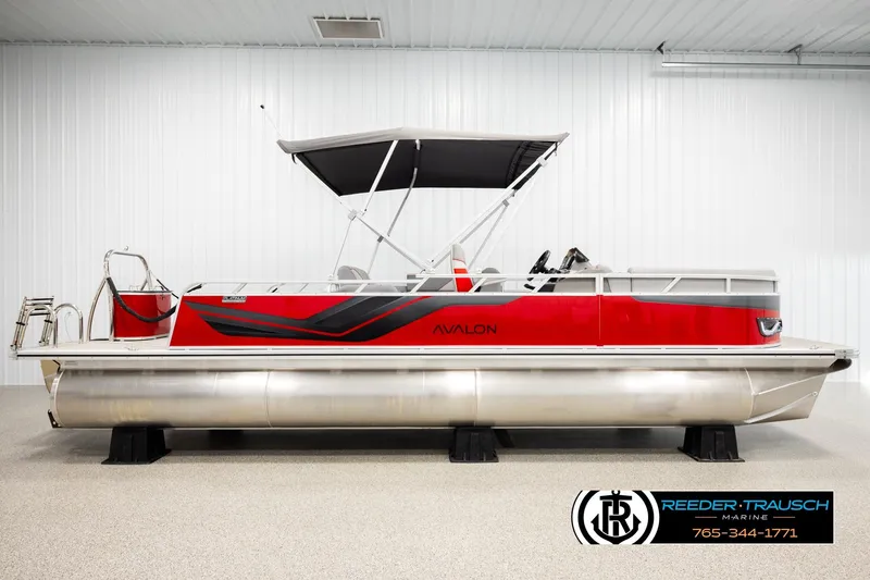 Slide: The Image of 2026 Avalon VEN85 VRB pontoon boat, red and silver, displayed indoors with canopy. - 5
