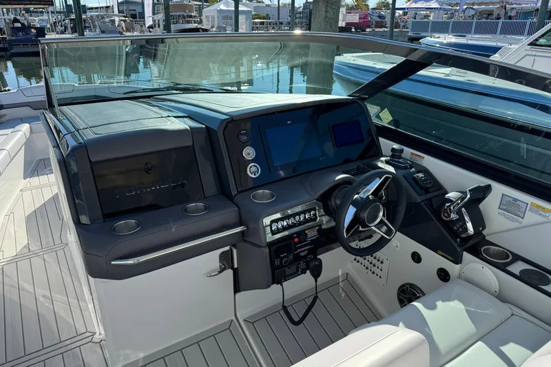 Slide: The Image of 2026 Formula 330 Crossover Bowrider OB helm with modern controls and sleek design. - 10