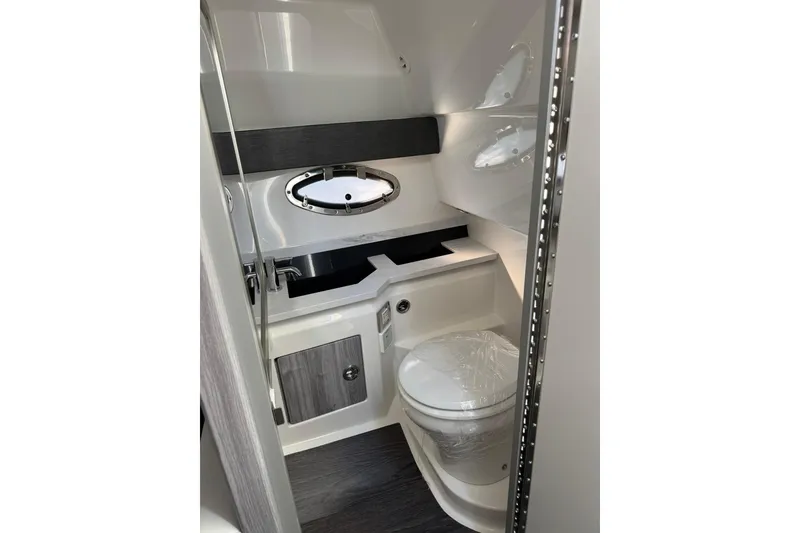 Slide: The Image of 2026 Formula 330 Crossover Bowrider OB bathroom interior with modern fixtures and porthole window. - 17