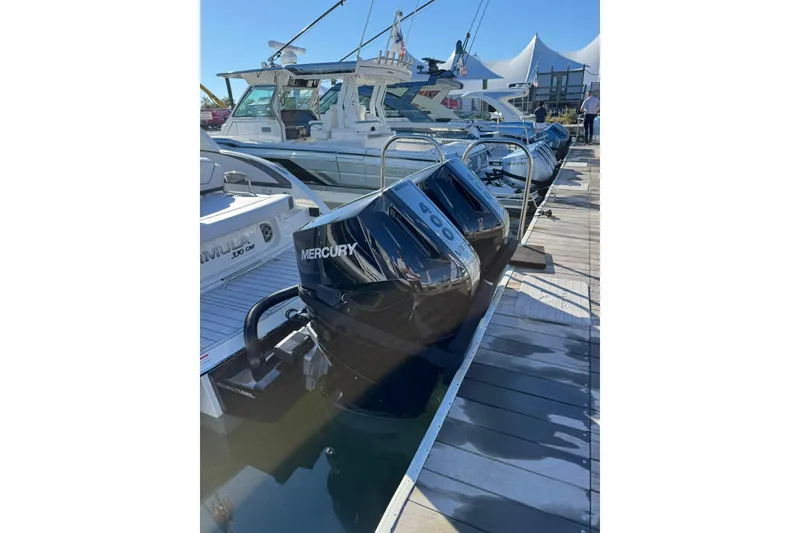 Slide: The Image of 2026 Formula 330 Crossover Bowrider OB with Mercury outboard engines docked at marina. - 4