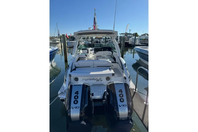 Slide: The Image of 2026 Formula 330 Crossover Bowrider OB with twin 400 V10 engines docked at marina. - 5