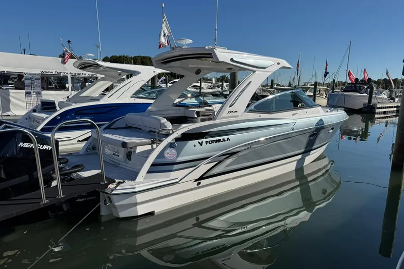 Slide: The Image of 2026 Formula 330 Crossover Bowrider OB boat docked at marina, sunny day. - 6