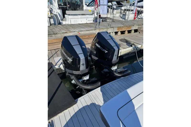 Slide: The Image of 2026 Formula 330 Crossover Bowrider OB with dual Mercury outboard engines at dock. - 7