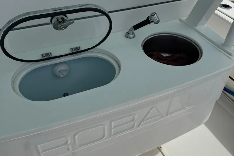 Slide: The Image of 2021 Robalo R272 Center Console boat sink and storage compartment. - 10