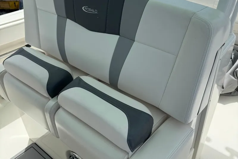 Slide: The Image of 2021 Robalo R272 Center Console boat seat with gray and white upholstery. - 12