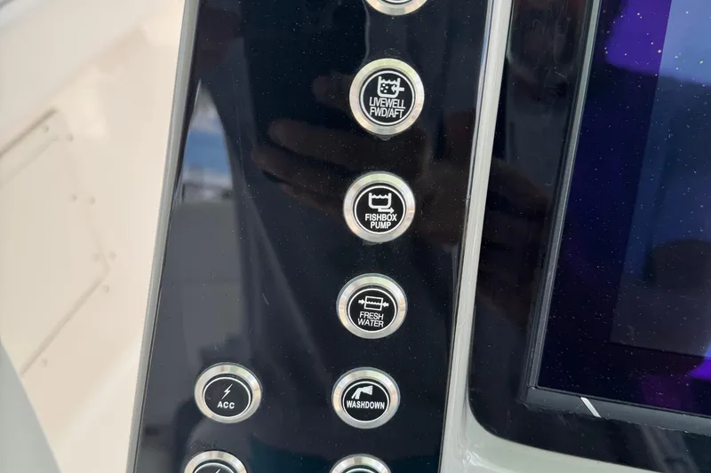 Slide: The Image of Control panel buttons on 2021 Robalo R272 Center Console boat dashboard. - 15