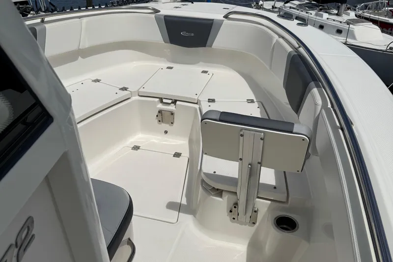 Slide: The Image of 2021 Robalo R272 Center Console boat interior with seating and storage compartments. - 18