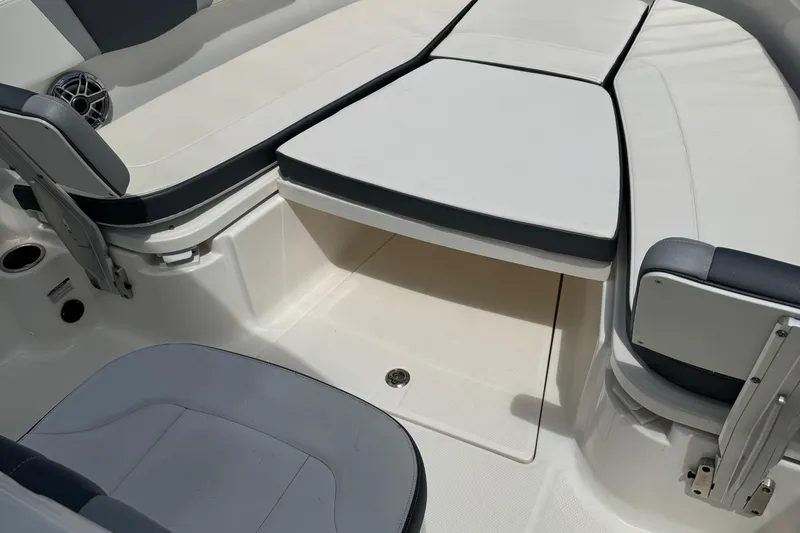 Slide: The Image of 2021 Robalo R272 Center Console boat interior with cushioned seating and storage. - 19