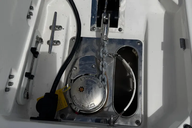Slide: The Image of Anchor compartment of 2021 Robalo R272 Center Console boat with winch and chain. - 25