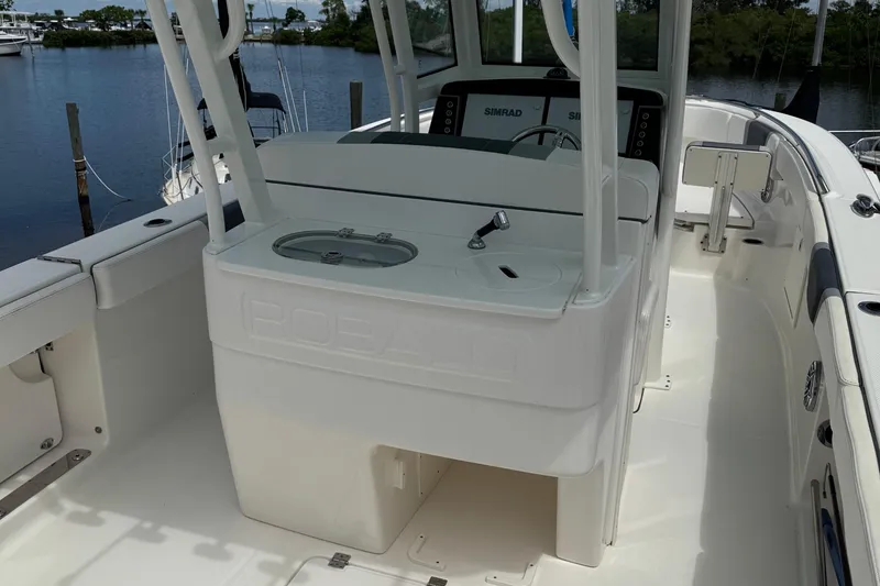 Slide: The Image of 2021 Robalo R272 Center Console boat interior with helm and seating area. - 6