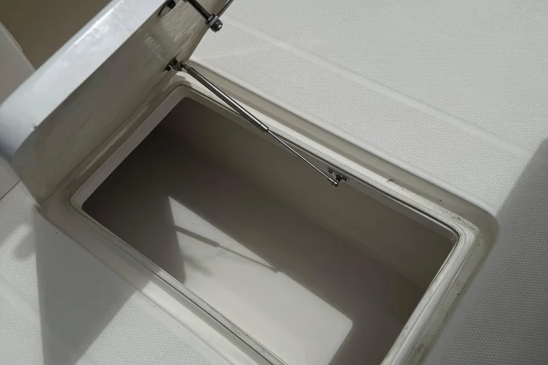 Slide: The Image of Open storage compartment on a 2021 Robalo R272 Center Console boat. - 9